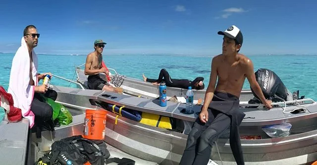 Research team conducting fieldwork in turquoise lagoon